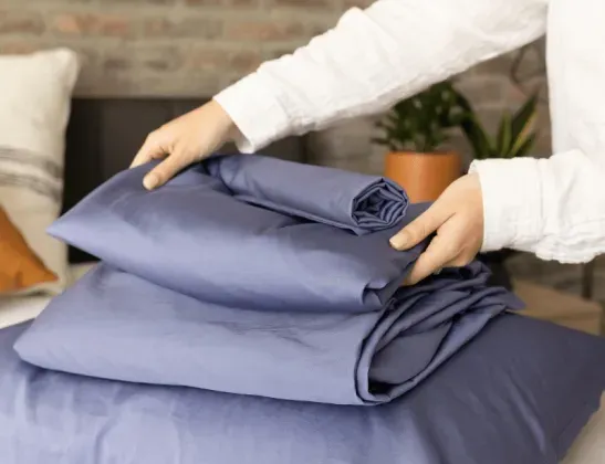 dreamfit-womans-hands-stacking-navy-blue-egyptian-cotton-sheets